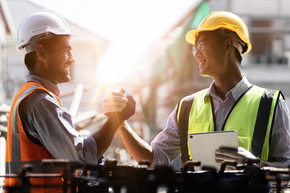 Manufacturing employees greeting each other