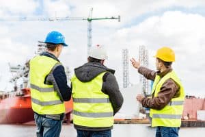 Senior engineer builder at the construction site in a port