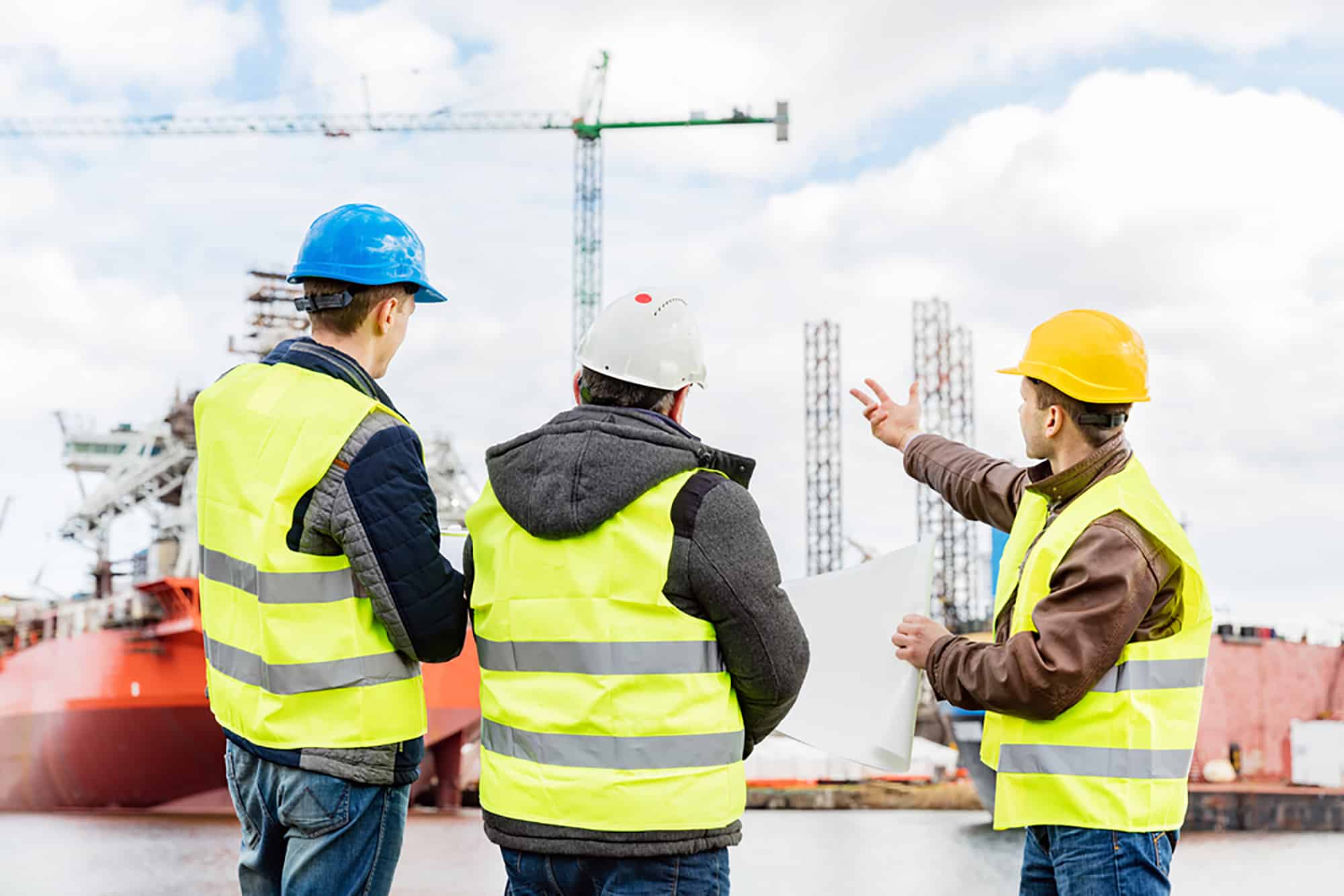 Senior engineer builder at the construction site in a port