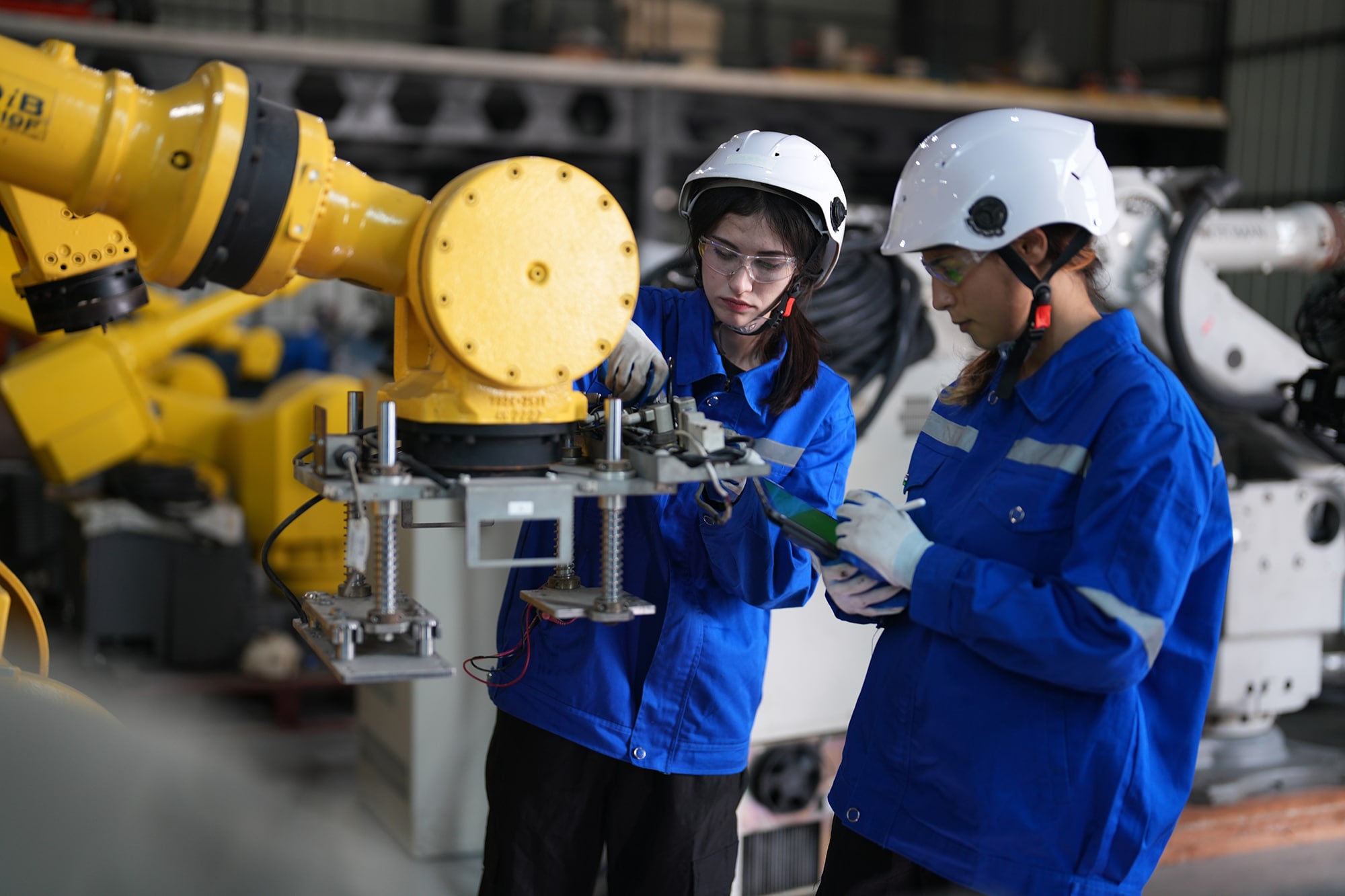 Female engineers checking AI robot training kit and mechatronics engineering