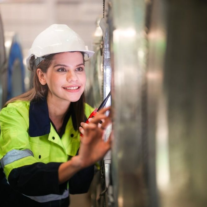 Engineer woman inspecting and checking store at warehouse of steel role material