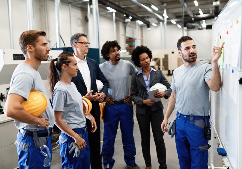 Happy manual worker presenting the results of business development Happy manual worker presenting the results of business development