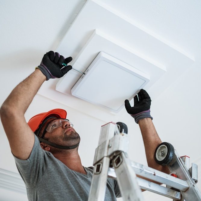 electrician installing a led light on the ceiling electrician installing a led light on the ceiling