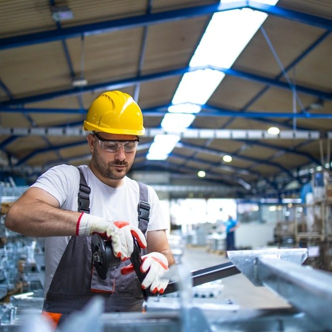 Working in factory assembling parts in production line