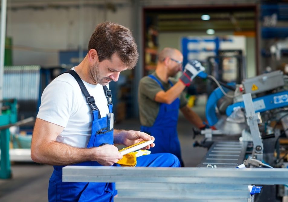 two worker in factory on the machine