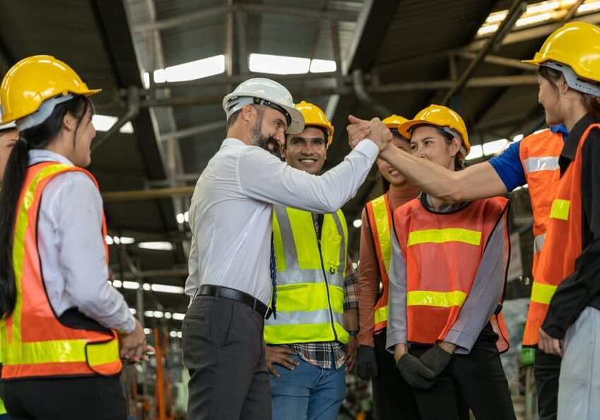 factory workers celebrating the success together