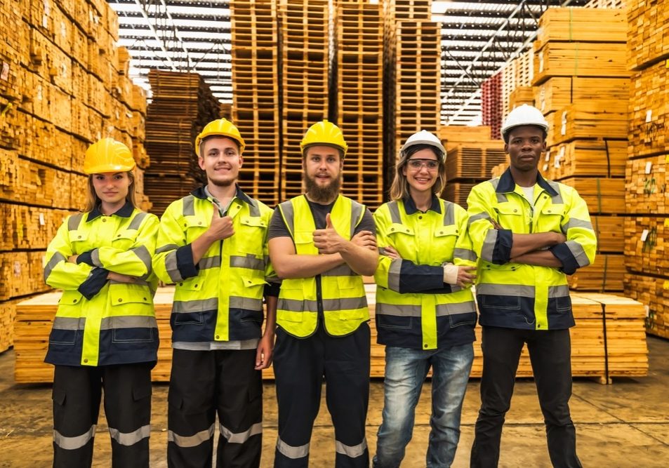 Photo group of wood worker men and women team standing in distribution factory warehouse