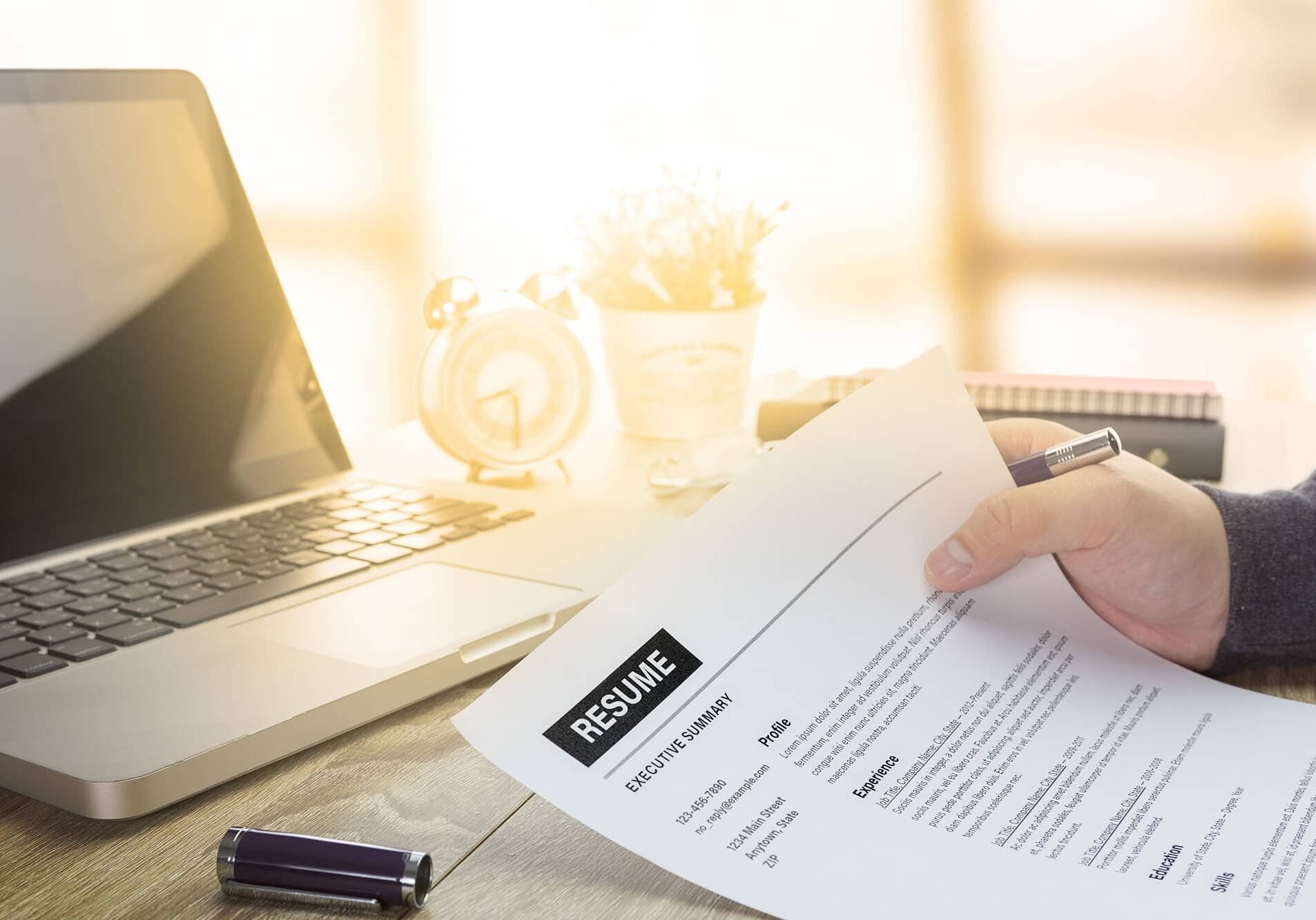job seeker review his resume on his desk before send to finding a new job