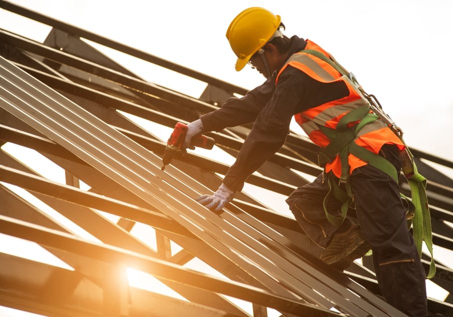 Construction engineer wear safety uniform using an electric drill and screw tools