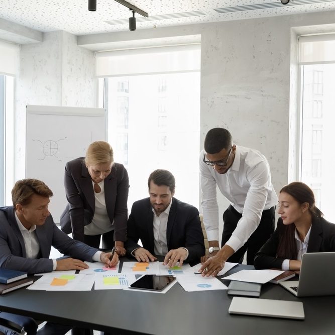 Diverse business team discussing project reports and marketing strategy Diverse business team discussing project reports and marketing strategy