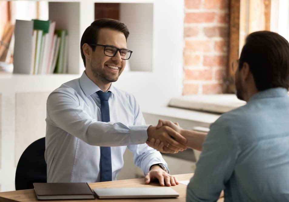 HR manager handshakes manufacturing position candidate HR manager handshakes manufacturing position candidate