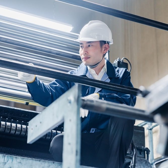 A male worker working at a scaffold at a high elevation